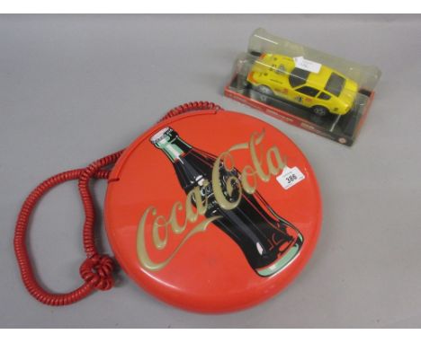 Coca Cola wall mounted telephone together with a Magorette scale model racing car