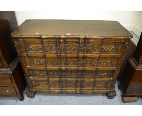 Continental oak commode chest having moulded top above four shaped and carved drawers on heavy paw feet