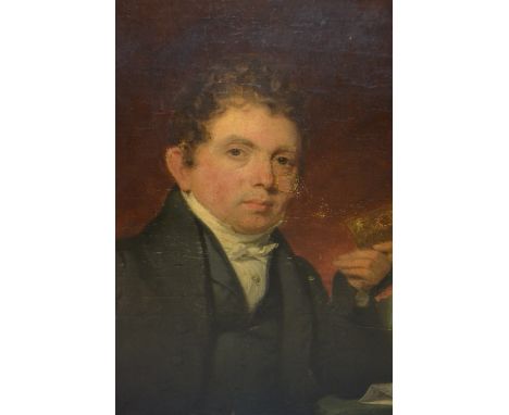 Early 19th Century, oil on canvas, portrait of a seated gentleman holding a leather bound book, 27ins x 23ins, gilt framed