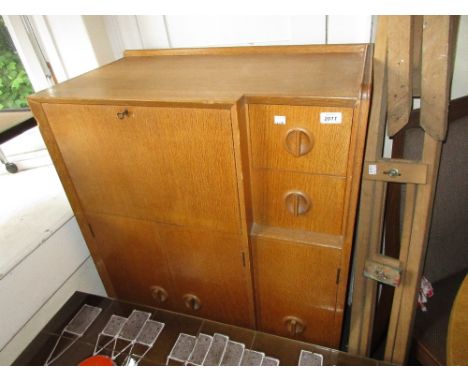 Mid 20th Century light oak bureau cabinet by White & Newton, with a fall front flanked by two small drawers and three doors b