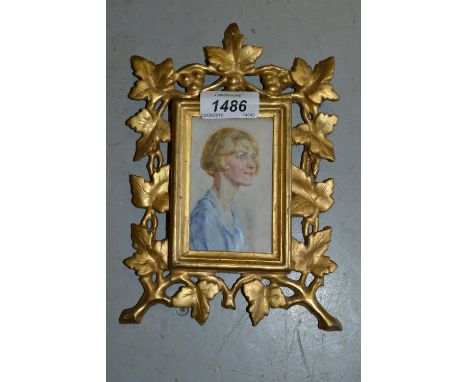 Miniature portrait, painting of a young lady, housed in a carved giltwood frame 