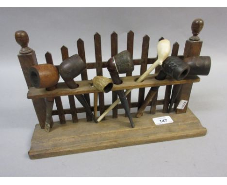 Pipe rack containing various clay and other pipes