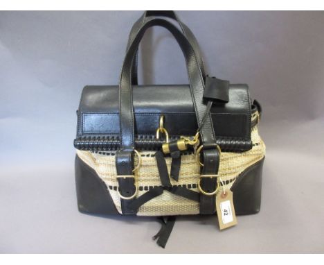 Ladies Yves St. Laurent black leather trimmed handbag, together with a ladies Fiorelli handbag