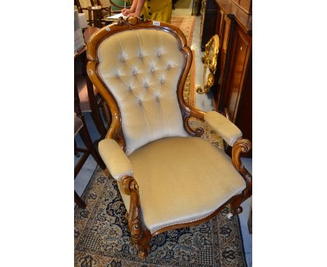 19th Century walnut spoonback open armchair having beige button back upholstery with carved cabriole front supports having br