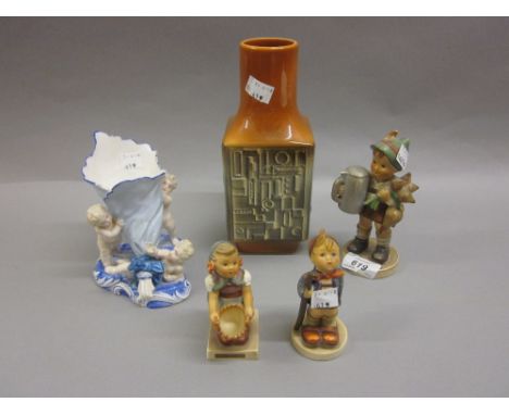 Three various Hummel figures, a porcelain cornucopia vase supported by three cherubs and a mid 20th Century relief moulded po