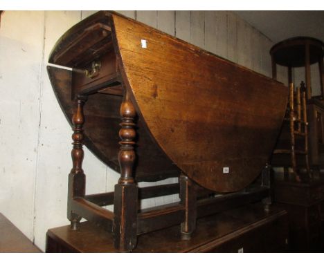 Early 18th Century oak oval gate leg dining table with a single end drawer on baluster turned supports with stretchers