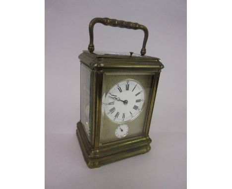 Late 19th / early 20th Century brass cased carriage clock, the gorge case enclosing a gilt engine turned face with enamel dia