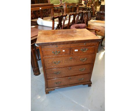 Antique oak dwarf chest, the moulded top with a brushing slide above two short and three long graduated drawers, raised on br