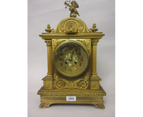 19th Century French ormolu mantel clock with cherub surmount, the gilded dial with Arabic numerals, the two train Japy freres