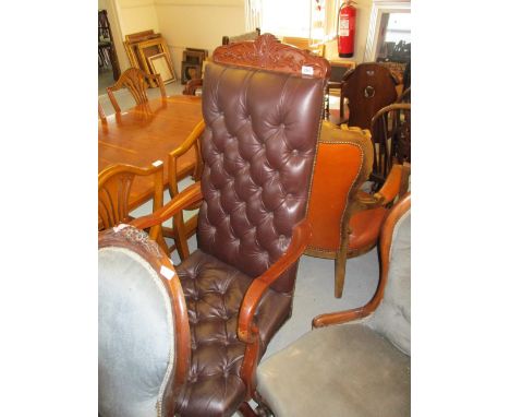 Reproduction brown button leather upholstered spoon back elbow chair, together with a reproduction brown buttoned leather rev