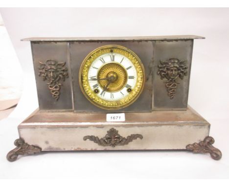 Polished steel cased 19th Century mantel clock having coppered metal mounts, the circular dial with Roman numerals and two tr