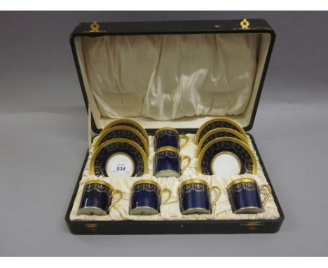 Cased set of six Limoges for Harrods coffee cups with saucers with gilded decoration on a dark blue ground