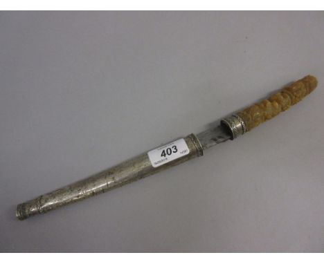 Eastern dagger having intricately carved horn handle and white metal covered scabbard having a steel blade, 12ins long