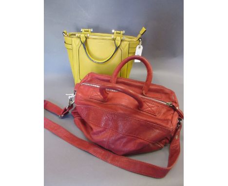 Modern yellow handbag and a modern red handbag