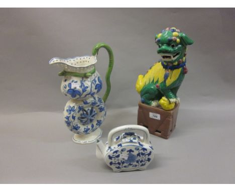 Modern Chinese porcelain dog of foe, similar blue and white teapot and a Continental pottery blue and white floral decorated 