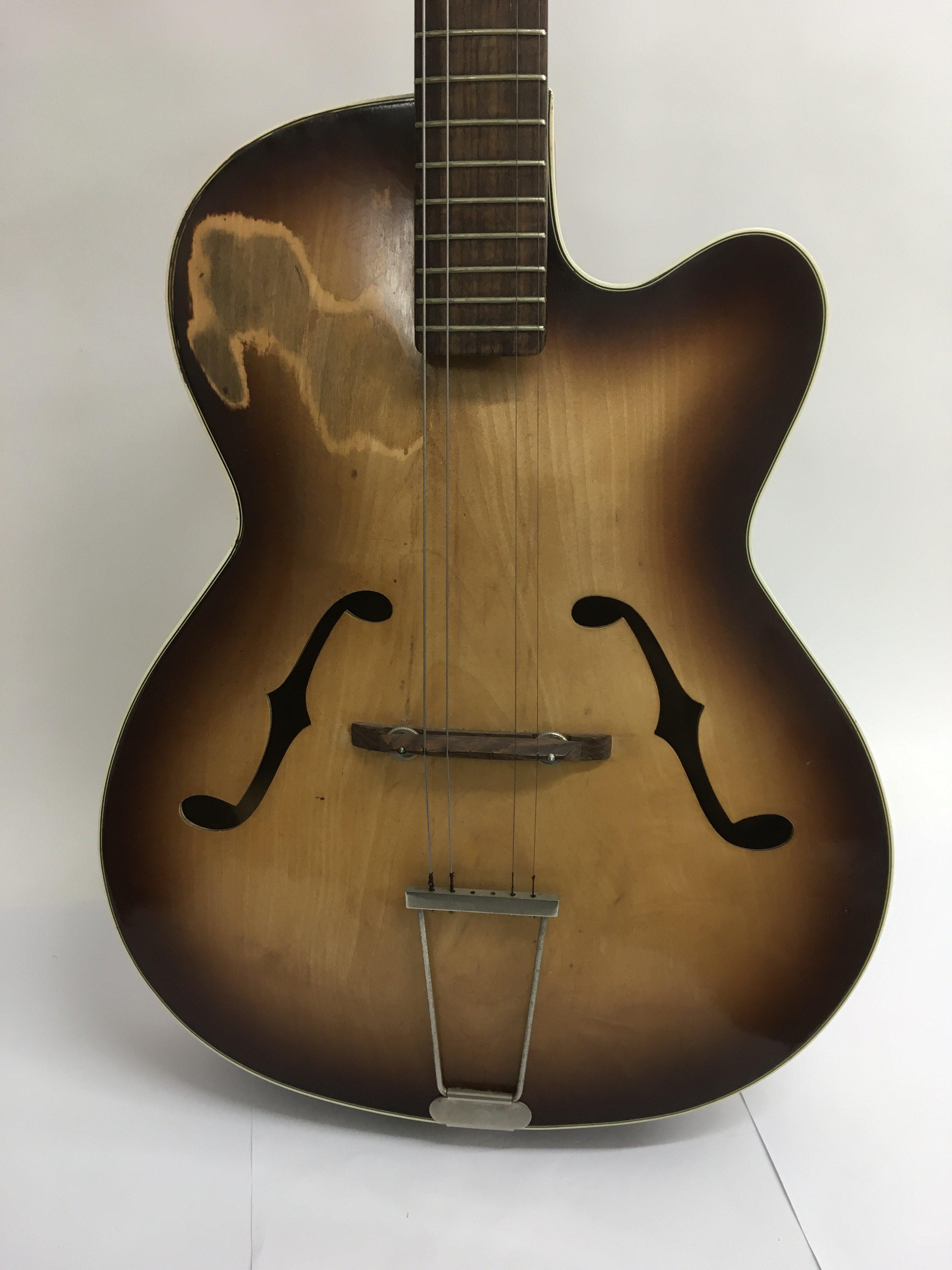 A vintage semi acoustic archtop guitar with f holes.