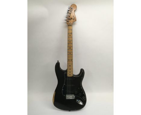 A 1974 Fender Stratocaster electric guitar in black with a black scratchplate, serial number 560 866. Originally purchased se