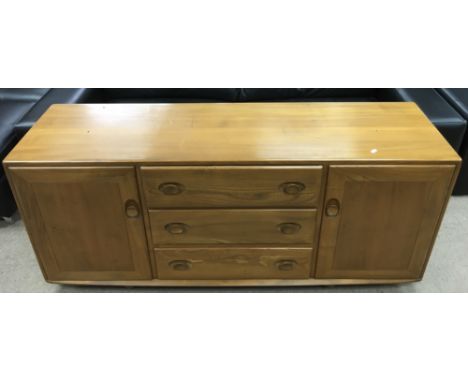 An Ercol light wood sideboard with three drawers the top having  two glass fronted display cabinets and one other.Approximate