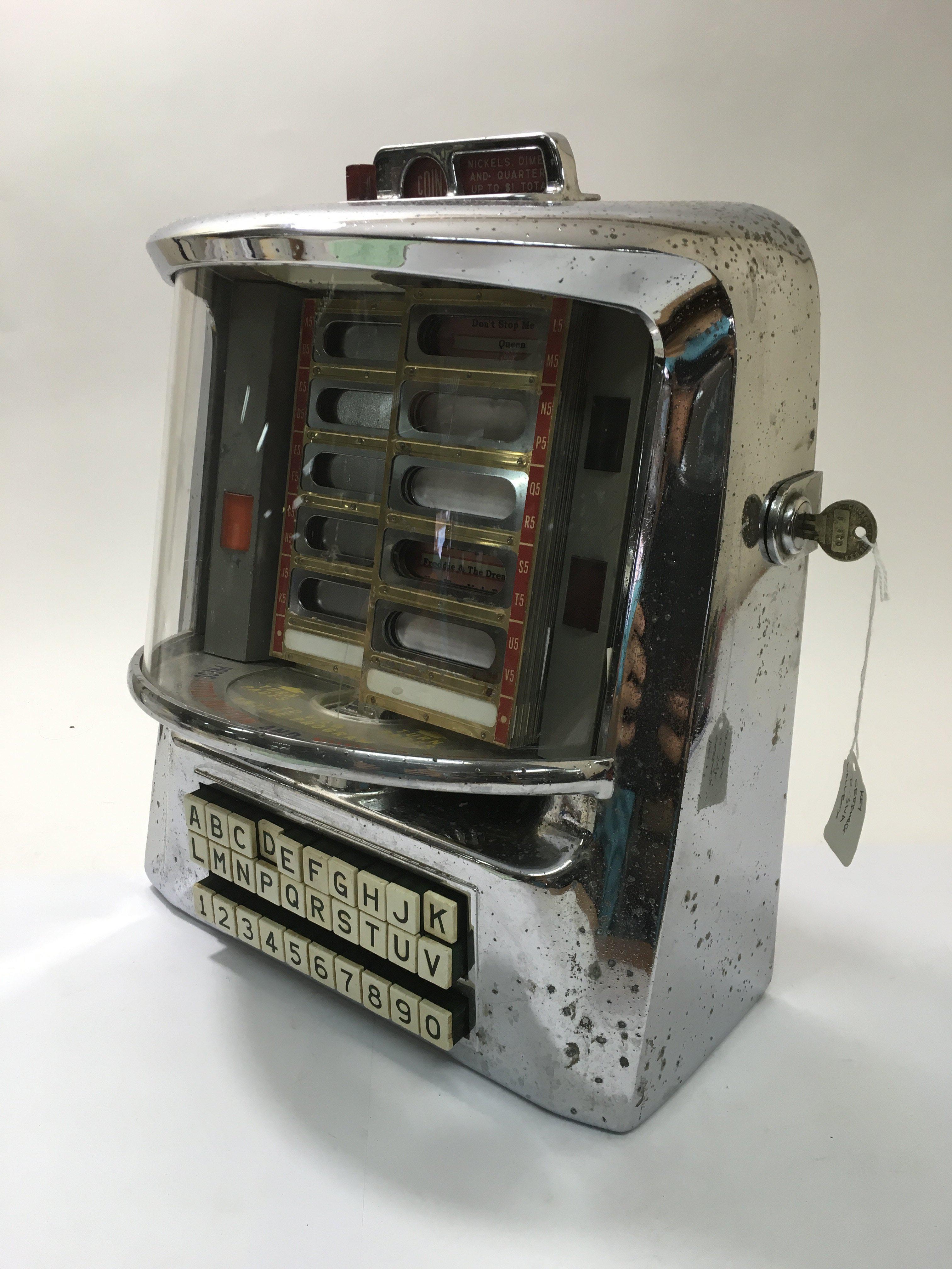 A late 1950's Seeburg table top jukebox complete with key, model number