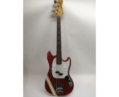 A 3/4 size Japanese Fender Mustang bass guitar in red with three stripe design and white pearloid scratch plate, serial numbe