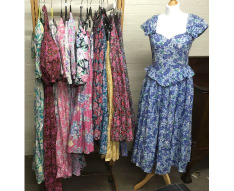 A collection of vintage 1980's Laura Ashley floral printed dresses and skirts.Sold with wooden hanging rail.
