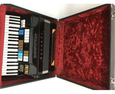 A cased Duovox Galanti electric accordion with separate Duovox amplifier (2).