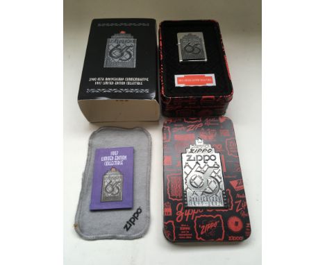 A boxed 65th anniversary Zippo lighter.