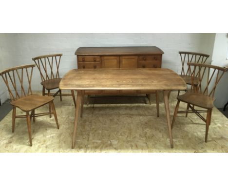 An Ercol light elm and oak wood dining suite comprising a sideboard, table and four conforming stickback chairs, impressed 19