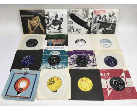 A collection of 7inch vinyl singles by various artists including The Beatles, Rolling Stones, Led Zeppelin, Buddy Holly and o