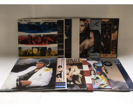 A box containing over 100 LPs and 12 inch singles by various artists including Michael Jackson, The Police, Primal Scream, Ma