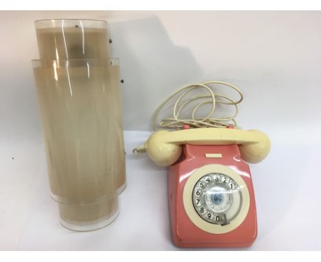 A vintage pink and cream two tone telephone and Perspex wall light