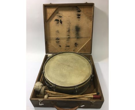 A vintage John Grey snare drum in a wooden case with various drumsticks.