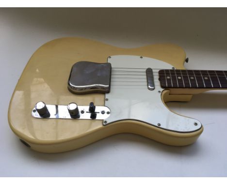 A Fender Telecaster guitar in butterscotch finish with a white scratch plate. Serial number on back plate is 542215 indicatin