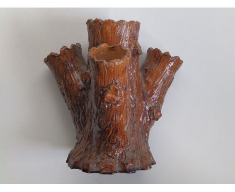 A Newton Abbot earthenware tree trunk vase.