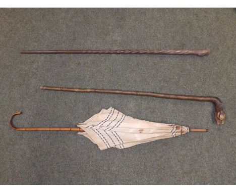 An African carved wood stick, one other and a parasol - a/f. (3)