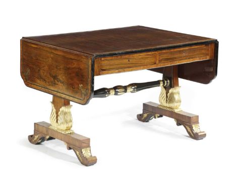 λ A REGENCY ROSEWOOD AND PARCEL-GILT SOFA TABLEEARLY 19TH CENTURYthe drop-leaf top inlaid with brass stringing and fleur-de-l