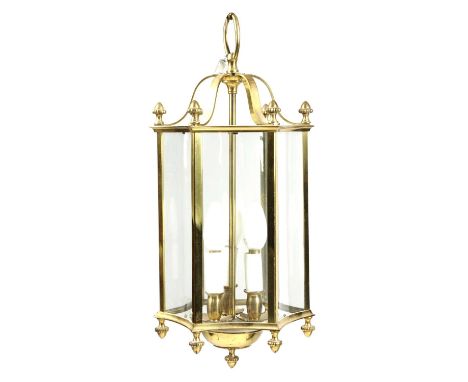 A SET OF THREE BRASS HALL LANTERNSIN REGENCY STYLE, 20TH CENTURYeach of concave hexagonal form with a triple light fitting an