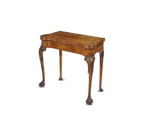 A WALNUT GAMES TABLEIN THE MANNER OF BENJAMIN CROOKthe cross and feather banded fold-over top revealing a backgammon and cheq