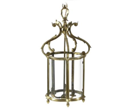 A SET OF THREE GILT BRASS HALL LANTERNSIN REGENCY STYLE, 20TH CENTURYeach of serpentine pentagonal form with a scrolling foli