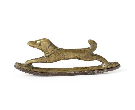 A FRENCH BRASS AND STEEL ZOOMORPHIC FIRE-STEEL OR STRIKERLATE 18TH CENTURYcast as a running hound on a gently curved steel7.4