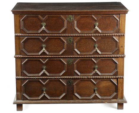 A CHARLES II OAK AND ELM CHESTC. 1680in two parts, the rectangular top with a moulded edge above four long twin octagonal mit
