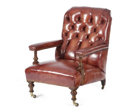 A LATE VICTORIAN EASY ARMCHAIRIN THE MANNER OF HOWARD & SONS, LATE 19TH CENTURYred leather upholstered on turned oak legs and