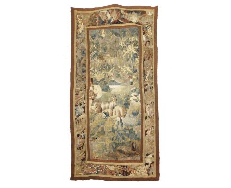 A FLEMISH TAPESTRY FRAGMENT17TH CENTURYwoven in silks and wool, the field depicting a rural scene of goats grazing in a woode