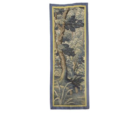 AN AUBUSSON TAPESTRY FRAGMENT17TH CENTURYwoven in silk and wool, the field depicting trees and a verdant landscape, enclosed 