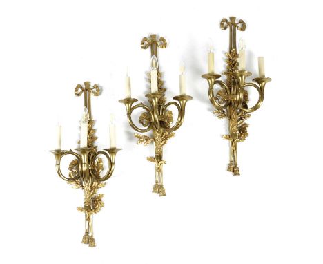 A SET OF THREE GILT BRASS 'AUX CORS DE CHASSE' WALL LIGHTSIN LOUIS XVI STYLE, AFTER GALLIEN AND BUREAUX, 20TH CENTURYeach wit