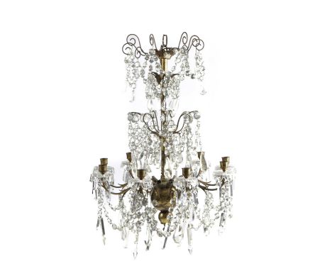 A BRASS AND CUT GLASS CHANDELIER20TH CENTURYwith nine scrolling branches with brass nozzles and glass swags issuing from a ba