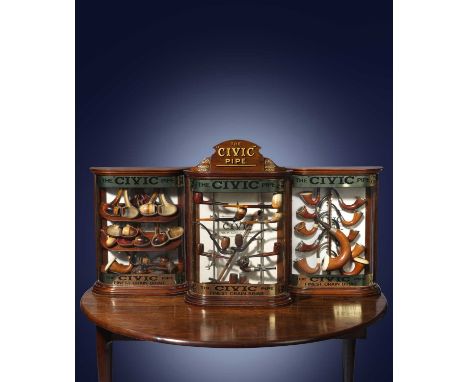 λ A SET OF THREE MAHOGANY 'CIVIC' PIPE TOBACCONIST SHOP COUNTER DISPLAY CABINETSEARLY 20TH CENTURYof bowfront form, one with 