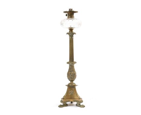 A REGENCY BRONZE OIL LAMPC.1820the clear glass reservoir above a reeded stem with a foliate base on a lion paw tripod base, f