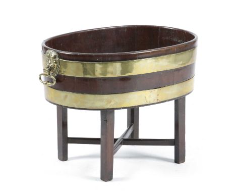 A GEORGE III MAHOGANY AND BRASS BOUND OVAL WINE COOLERATTRIBUTED TO GILLOWS, LATE 18TH CENTURYwith lion's mask ring handles, 