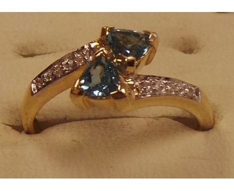 Gold diamond and topaz twist ring